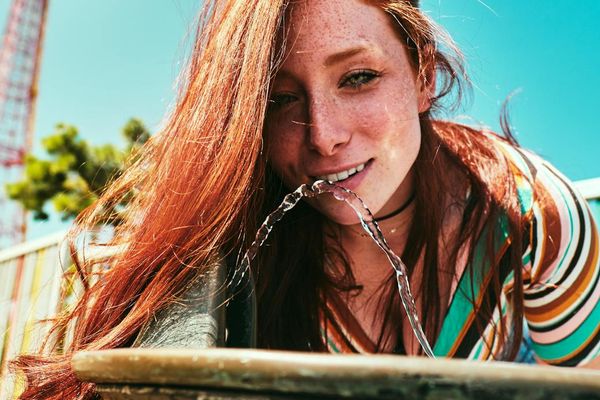 A person looking vibrant and energetic in an urban park setting.